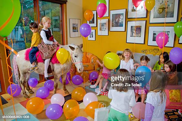 children (4-9) at birthday party - pony stock pictures, royalty-free photos & images