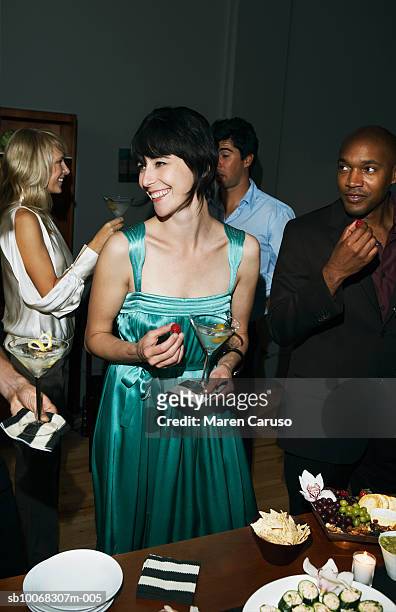 group of friends socializing at cocktail party - abbigliamento formale foto e immagini stock