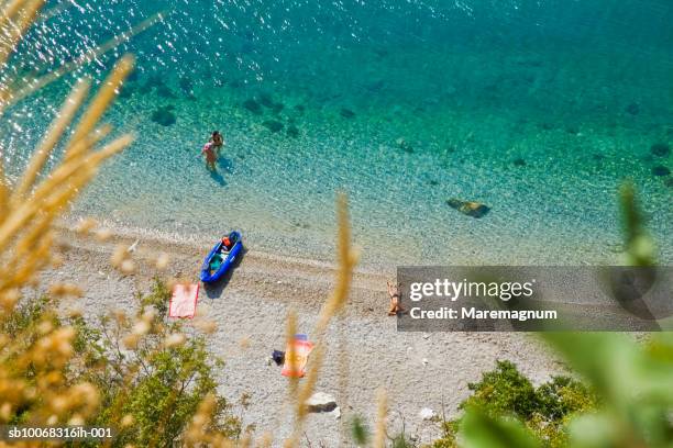 italy, friuli venezia giulia, duino, people on beach - duino coast stock-fotos und bilder