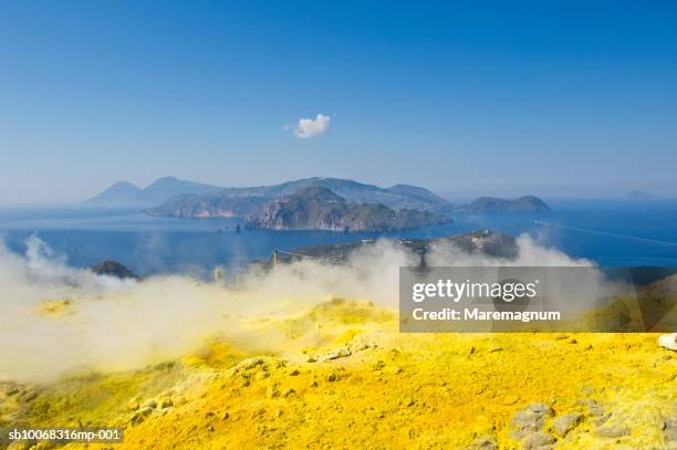 italy, sicily, eolian archipelago, sulfur covered side of volcano overlooking sea - sulphur stock pictures, royalty-free photos & images