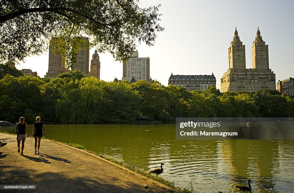 USA, New York, Central Park, couple walking by pond