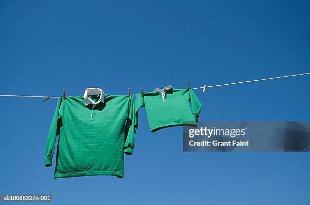 rugby shirts drying on string - green shirt stock pictures, royalty-free photos & images