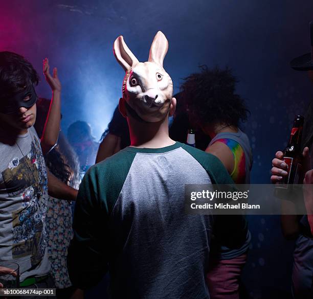 man in bunny mask dancing in night club - mask disguise stock pictures, royalty-free photos & images