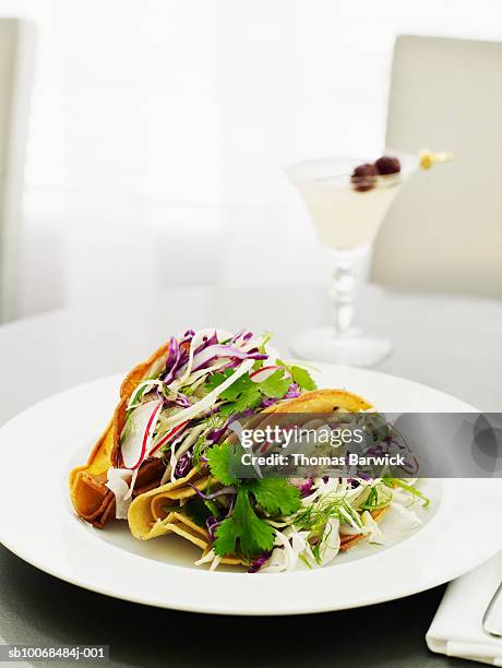 fish tacos with cod, salsa verde, fennel and cabbage, cocktail in background - cod stock pictures, royalty-free photos & images