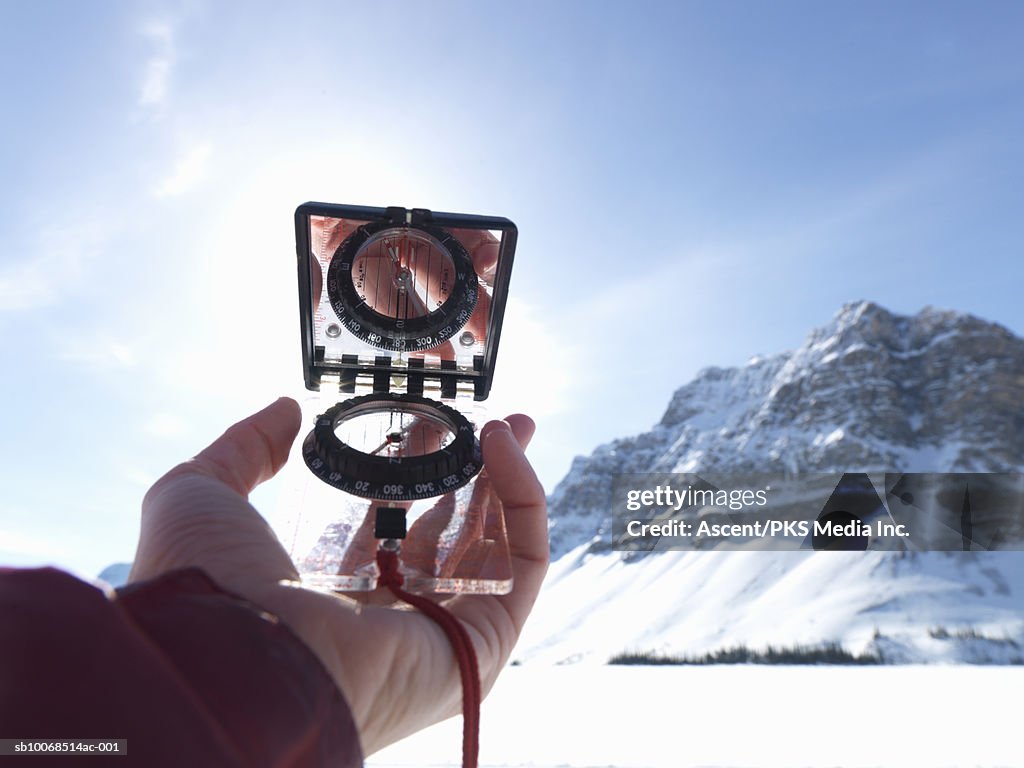 Man's hand holding compass, close-up