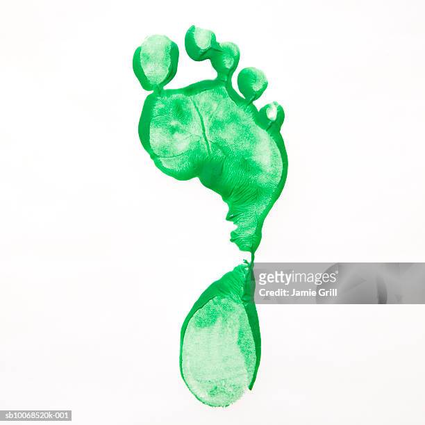 green foot print against white background, close-up - footprint stock pictures, royalty-free photos & images