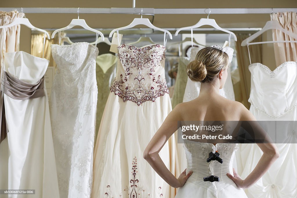 Bride looking at rack of dresses