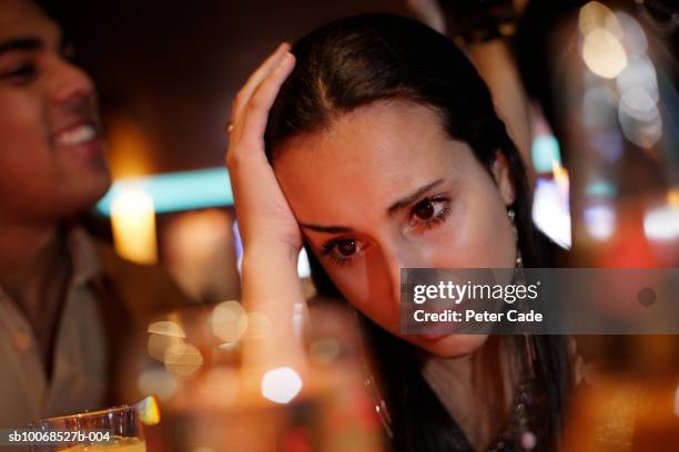 teenage girl (16-17) sitting in pub with head in hand - grumpy girl stock pictures, royalty-free photos & images