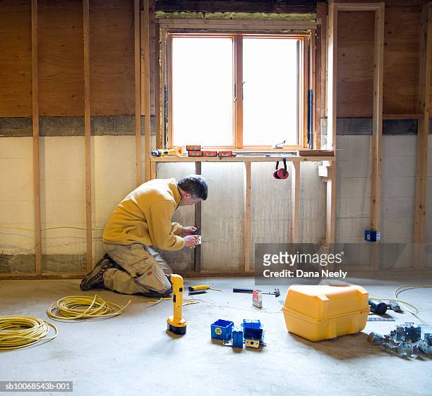 man working in construction site, side view - window installation stock pictures, royalty-free photos & images