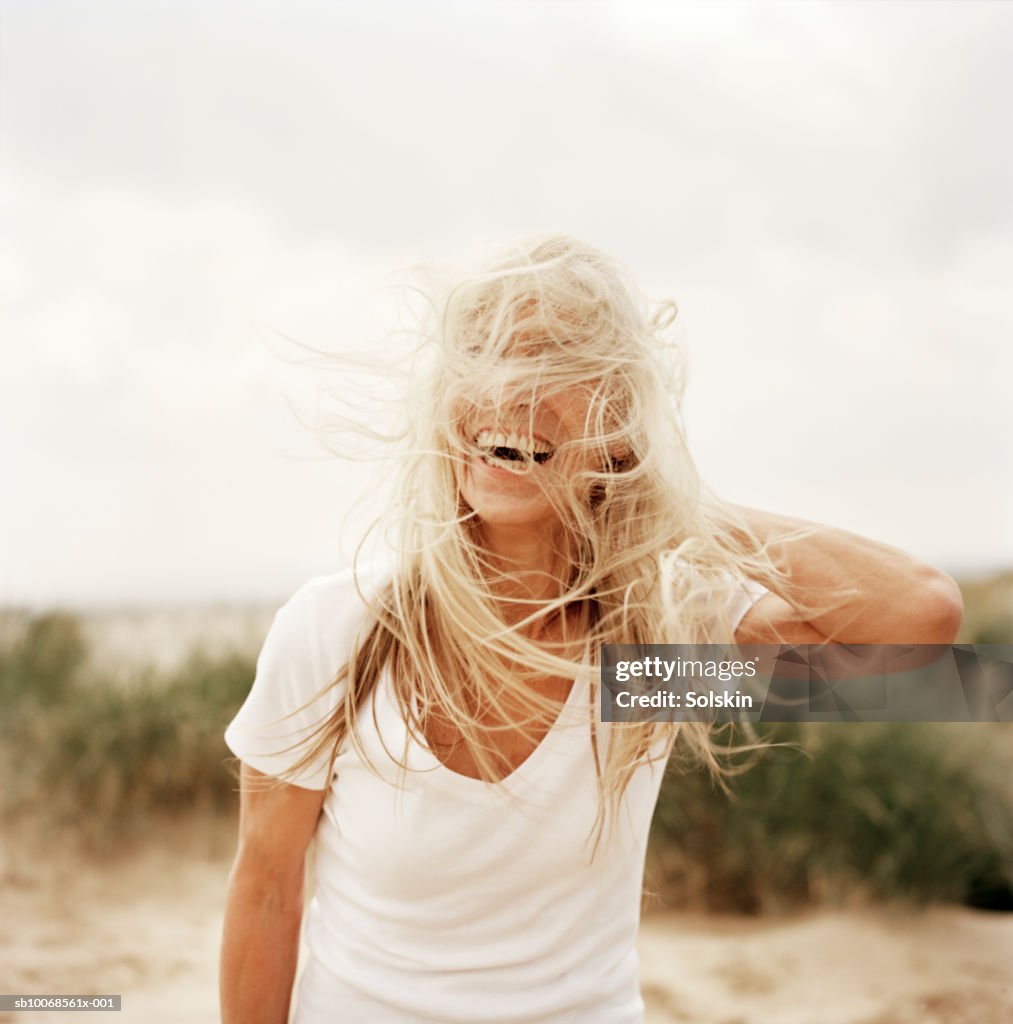 Woman with windswept hair on beach