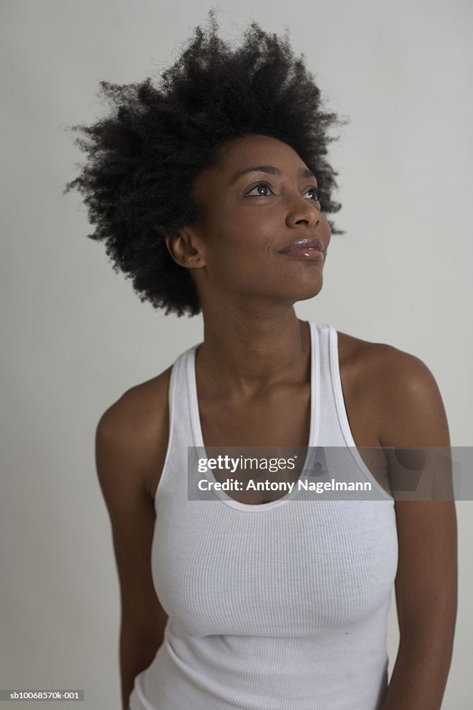 Woman looking up, studio shot