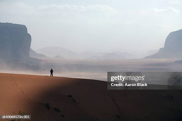 jordan, wadi rum, man standing in desert - desert area stock pictures, royalty-free photos & images