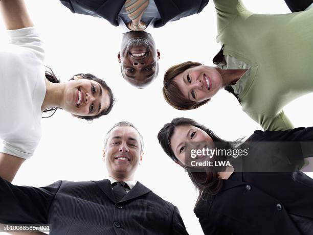 group of businesspeople in huddle, smiling, view from below, portrait - japanese bussiness woman looking up imagens e fotografias de stock