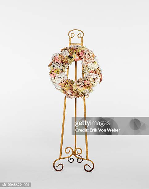 flower wreath on stand on white background - funeral flowers stock pictures, royalty-free photos & images