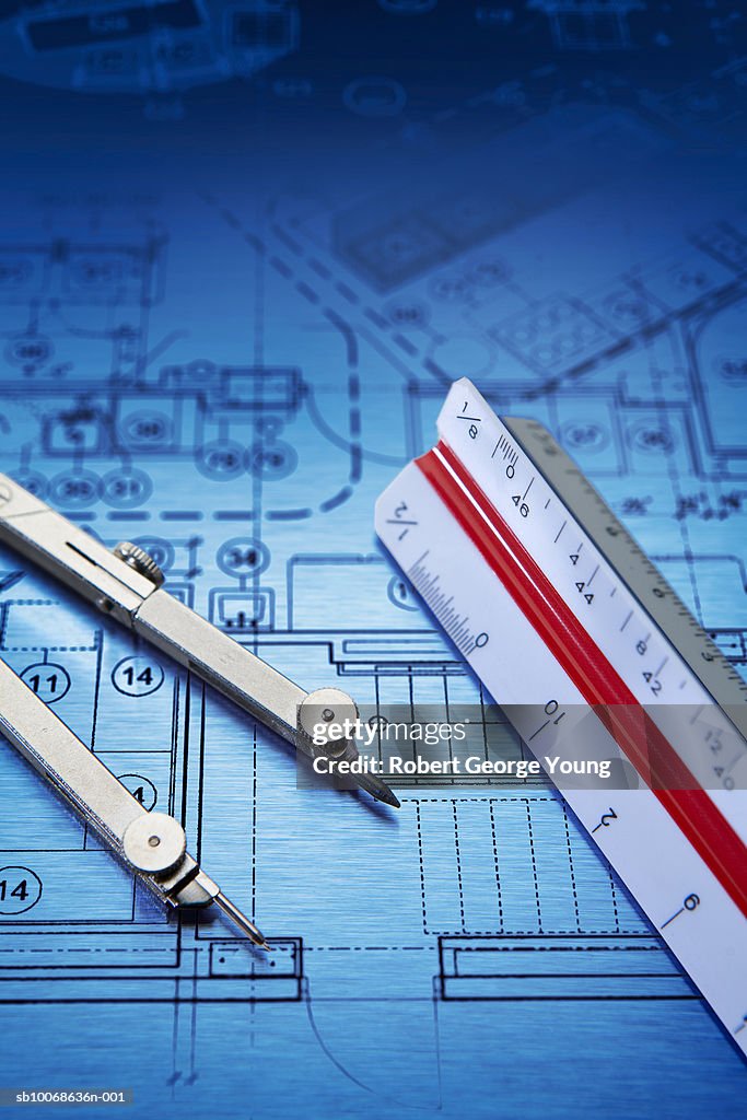 Blueprint, scale ruler and drawing compass