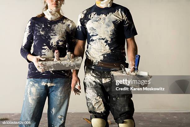 couple doing plaster, mid section - gips bouwmateriaal stockfoto's en -beelden