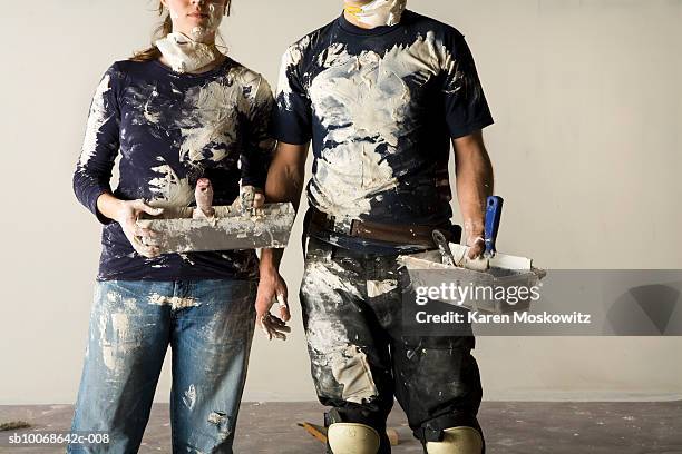couple doing plaster, mid section - shoddy construction stock pictures, royalty-free photos & images