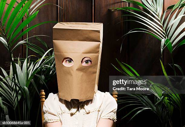 woman with paper bag on head (digital composite) - timido foto e immagini stock