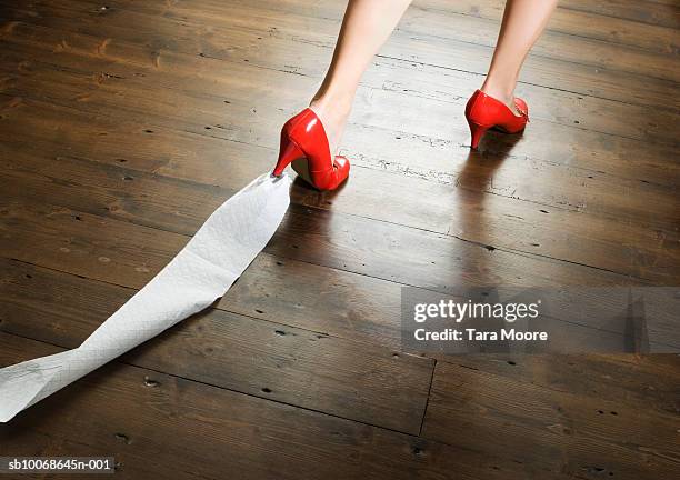 woman with toilet paper stuck to shoe, low section - peinlich stock-fotos und bilder