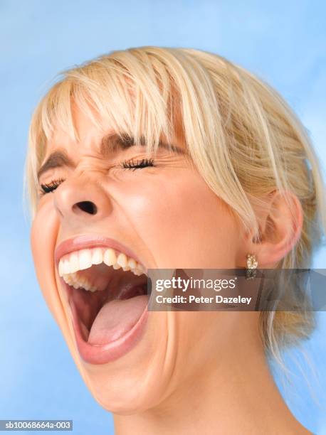 young woman screaming, close up, studio shot - boo face stock pictures, royalty-free photos & images