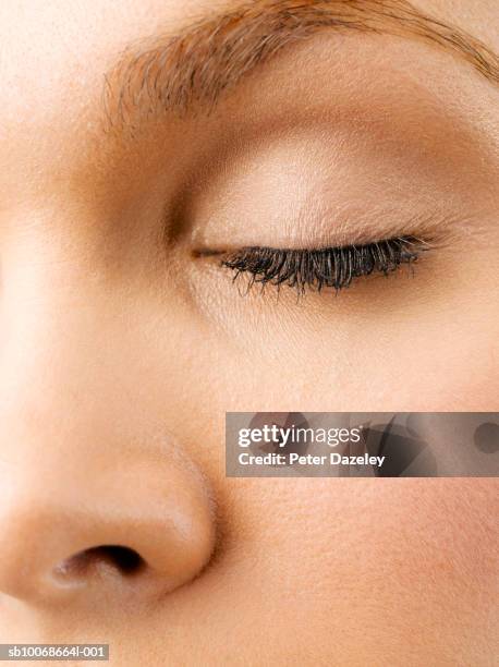 young woman with closed eyes, close up of eye, studio shot - woman eyes closed stock pictures, royalty-free photos & images