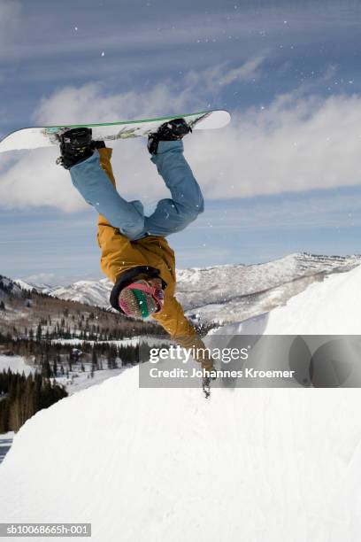 young man doing trick on snowboard - legs in the air stock pictures, royalty-free photos & images