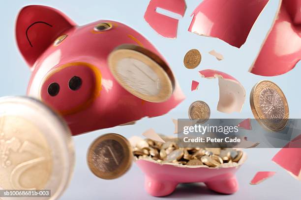 piggy bank exploding - smashed piggy bank stock pictures, royalty-free photos & images