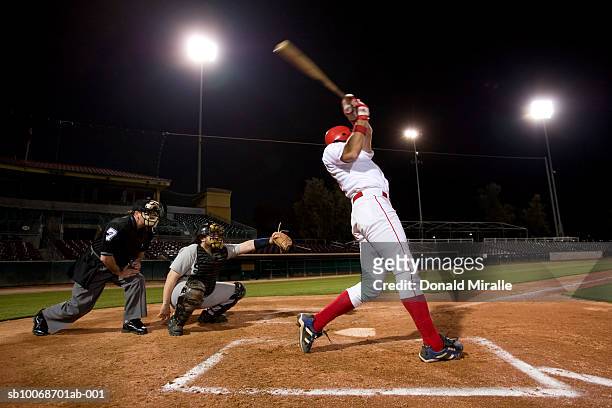 usa, california, san bernardino, baseball players with batter swinging - baseball stock pictures, royalty-free photos & images