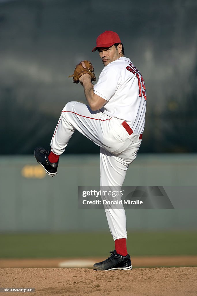 USA, California, San Bernardino, baseball pitcher preparing to throw, outdoors