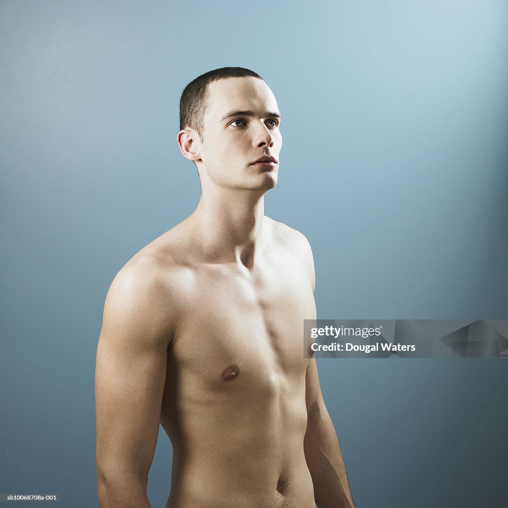 Young man against blue background