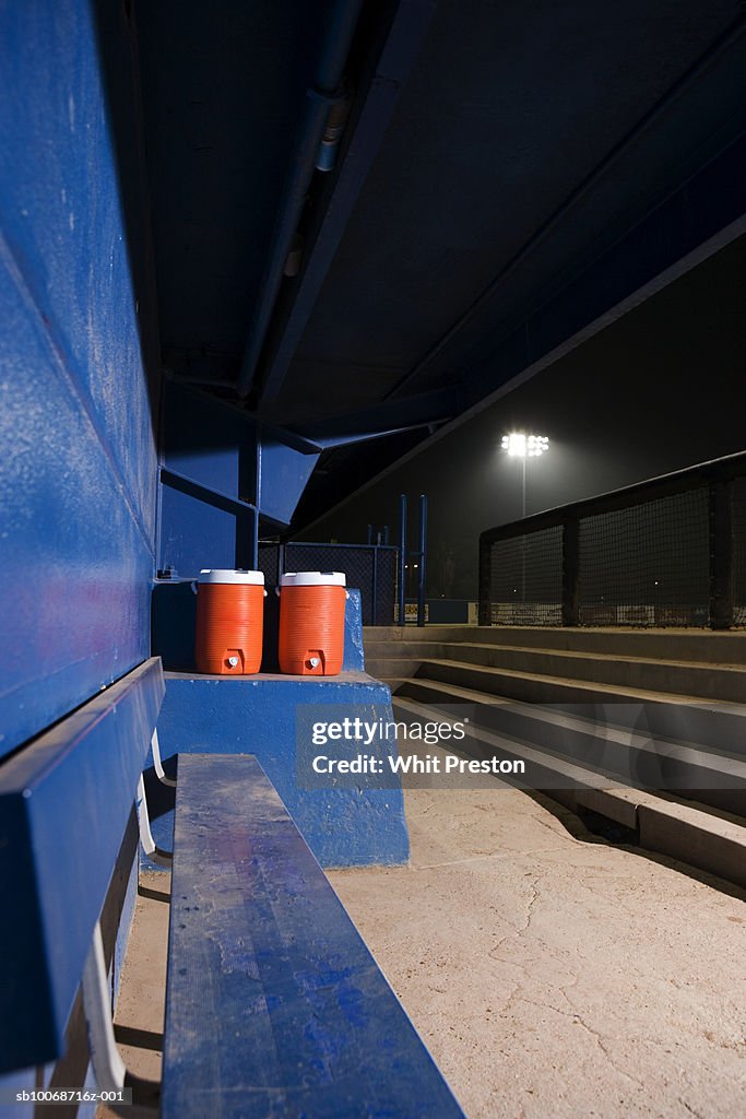 Empty baseball dugout with water coolers