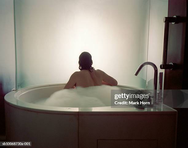 man in bathtub looking at window, rear view - rear window stock pictures, royalty-free photos & images