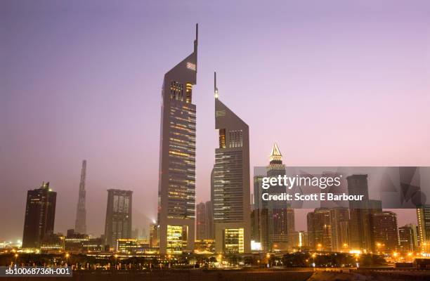 united arab emirates, dubai, sheikh zayed road at dusk - emirates towers stock pictures, royalty-free photos & images