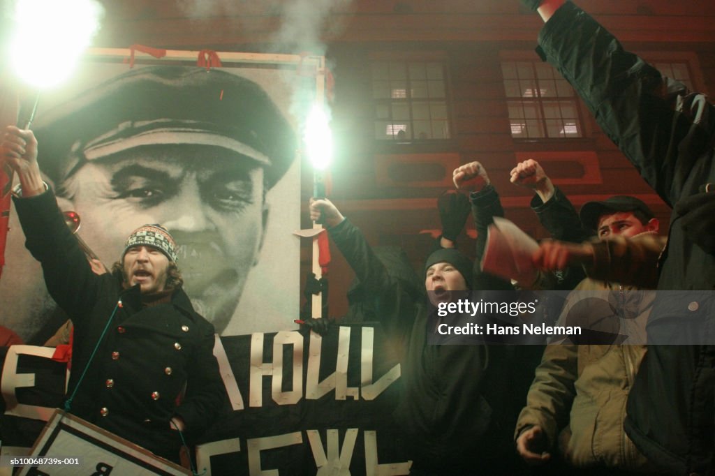 People holing burning torch in demonstration