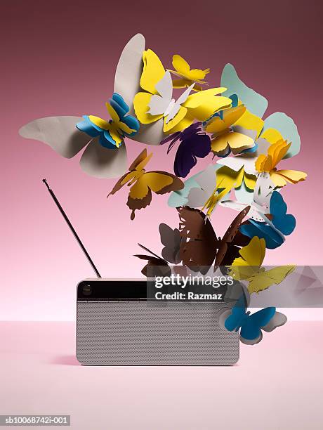 fake butterflies and radio, close-up - fake-butterflies stock pictures, royalty-free photos & images