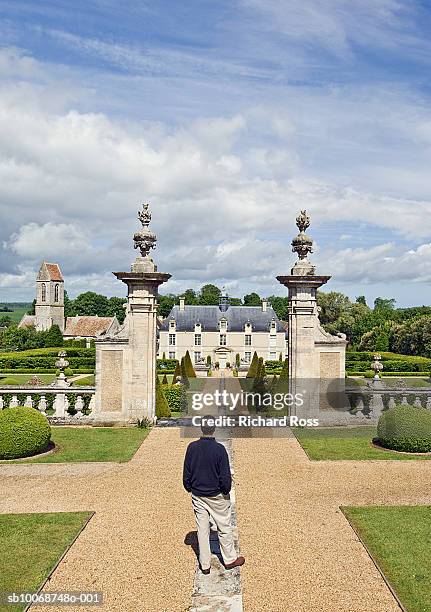 france, normany, man looking at chateau - french chateau stock pictures, royalty-free photos & images