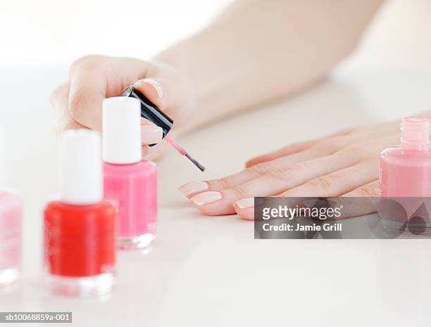 woman painting nails, close-up - manicure fotografías e imágenes de stock