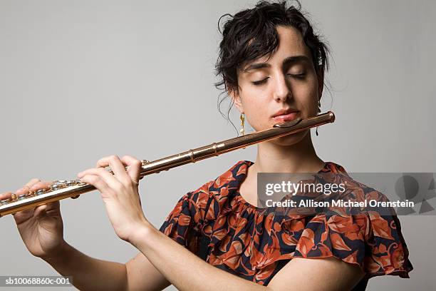 woman playing flute, eyes closed, close-up - 木管楽器 ストックフォトと画像