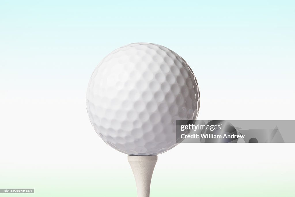 Golf ball on white tee, close-up