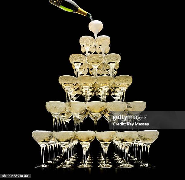 tower of champagne glasses, studio shot - überfluss stock-fotos und bilder