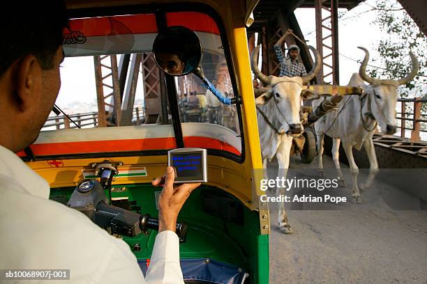 rickshaw driver using satellite navigation device on bridge - automotive navigation system stock pictures, royalty-free photos & images