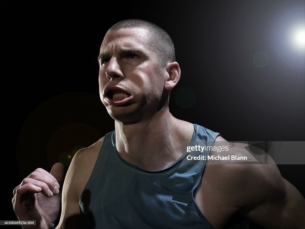 Male athlete running, close-up