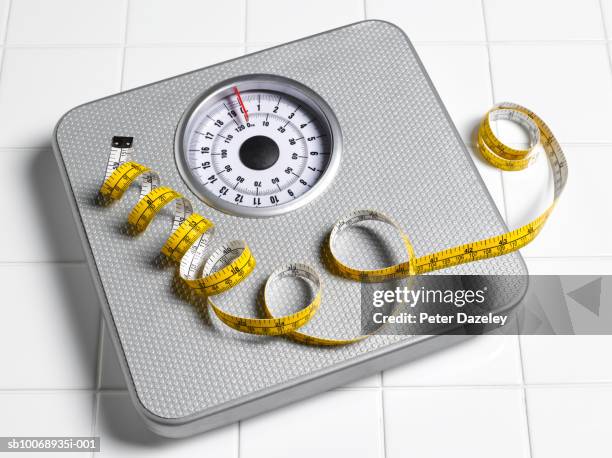 tape measure on scales, close-up - balansvåg bildbanksfoton och bilder