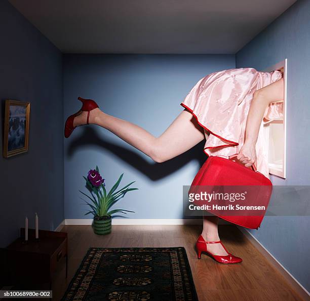 woman in small living room with head out of window, low section, side view - escaping room stock pictures, royalty-free photos & images