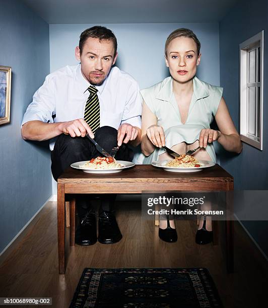 couple eating dinner in small dining room, portrait - minute dating stock pictures, royalty-free photos & images