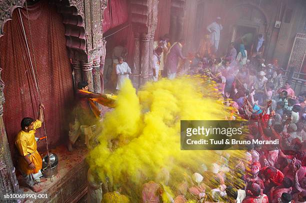 india, people in front of temple during holi festival - community festival stock pictures, royalty-free photos & images
