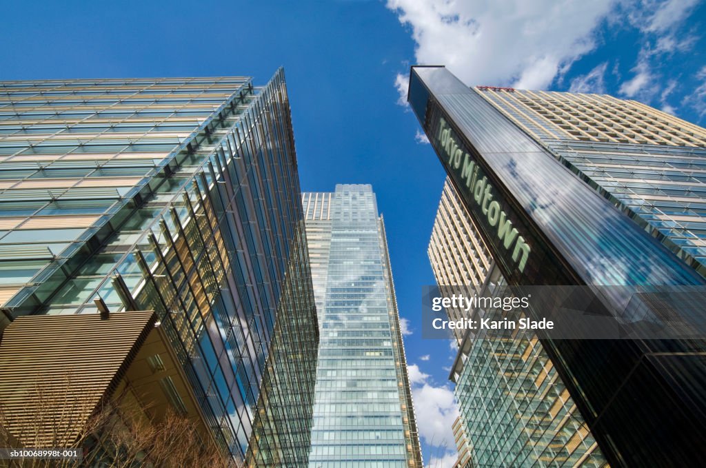 Japan, Tokyo, Minato-ku, Roppongi, Skyscrapers and Tokyo Midtown sign, low angle view