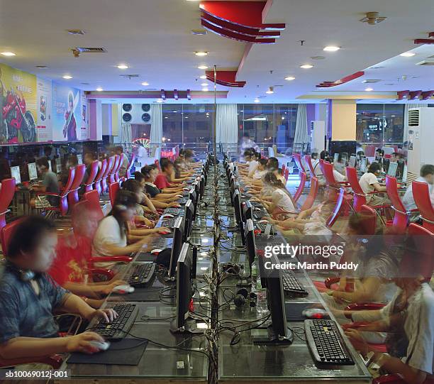 people in internet caft, ( long exposure) - internet cafe stockfoto's en -beelden