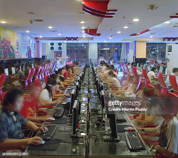 people in internet caft, ( long exposure) - internet cafe stock pictures, royalty-free photos & images
