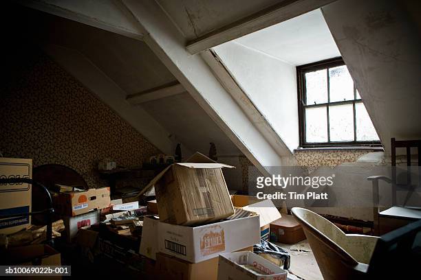 house attic filled with old items - forsaken film stock-fotos und bilder